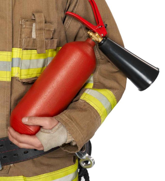 red extinguisher held by anonymous male firefighter